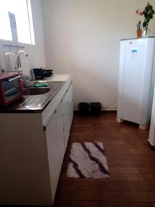 a kitchen with a sink and a white refrigerator at ChezElo in Extremóz