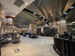 a lobby of a hotel with a chandelier at Spacious Loft in Gramercy in Manila