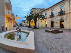 a street with a fountain in front of a building at Il Canto di Ligea in Lamezia Terme