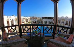 a balcony with chairs and a view of a city at Oriental Rivoli Hotel & Spa in Sharm El Sheikh