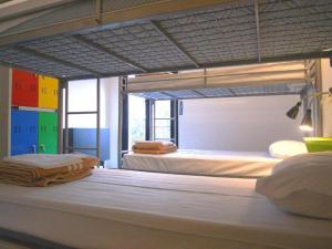 two bunk beds in a room with two beds at Hostel Colours in Milan