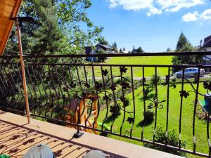 a balcony with a view of a field of grass at Noclegi Gal in Odrowąż