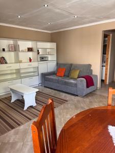 a living room with a couch and a table at Casa Nogal in El Bolsón