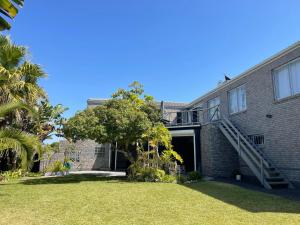 a brick house with a staircase on the side of it at Silver Sunsets Self-Catering Apartments in Cape Town