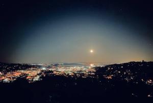 een uitzicht op een stad 's nachts met de maan bij Farm in the city with sweeping bay view in San Rafael