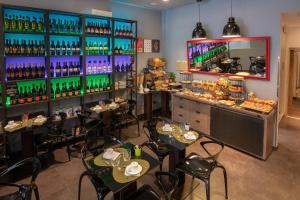 a restaurant with tables and chairs and a bar at Navona Colors Hotel in Rome