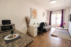 a living room with a couch and a table at Beautiful Apartment by the Sea in Playa San Juan in Playa de San Juan