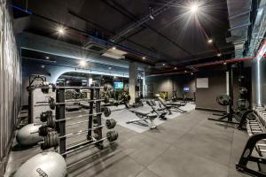 a gym with dumbbells and weights in a room at The Rockefeller Hotel by NEWMARK in Cape Town