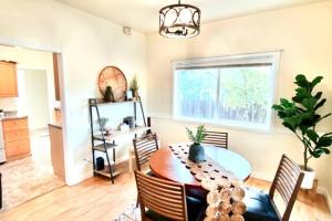 a dining room with a table and a window at The Cheerful Bungalow Family Home OSU PNW in Corvallis