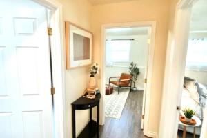 a hallway with a door open to a room with a chair at The Cheerful Bungalow Family Home OSU PNW in Corvallis