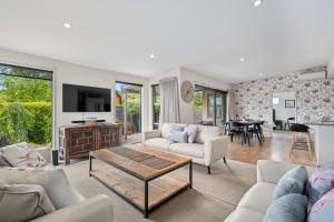 a living room with a couch and a table at Urban Oasis - Wanaka Holiday Home in Wanaka