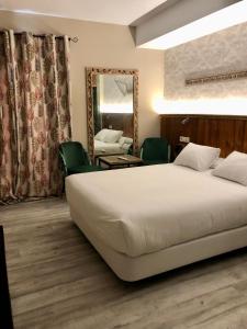 Postel nebo postele na pokoji v ubytování Alameda Hostal Boutique