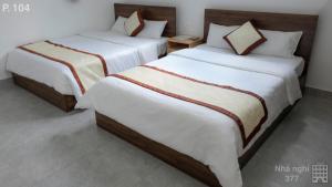 Postel nebo postele na pokoji v ubytování Vy An Hotel