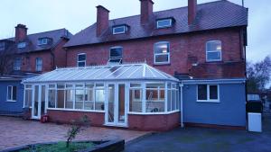 an extension to a house with a conservatory at Reach Guest House in Birmingham