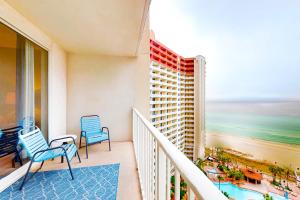 a balcony with two chairs and a view of the ocean at Shores of Panama 1517 in Panama City Beach
