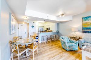 a living room with a table and chairs at Shores of Panama 1517 in Panama City Beach