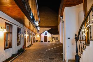 an empty alleyway in an old building at night at Althof Apartments in Sibiu