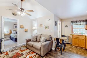 a living room with a couch and a table at Northwoods Lodge Cabin 1 in Morrisville