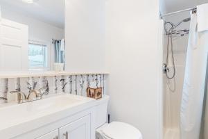 a bathroom with a sink and a toilet and a shower at Northwoods Lodge Cabin 1 in Morrisville +43 photos