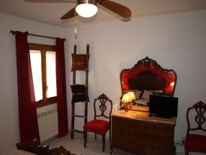 a bedroom with a dresser with a mirror and a chair at Casa Piquero in Sieste