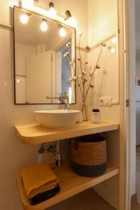y baño con lavabo y espejo. en Apartamento Tramuntana 3 en Cala Blanca
