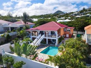 an aerial view of a house with a swimming pool at Villa Caribbean Star, 5 min walk from the beach in Orient Bay