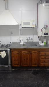 cocina con fregadero y microondas en Casa Facu en Godoy Cruz