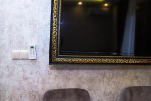a mirror and a lightswitch on a wall with a mirror at Sufra Suite in Istanbul