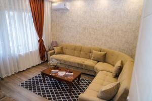 a living room with a couch and a coffee table at Sufra Suite in Istanbul