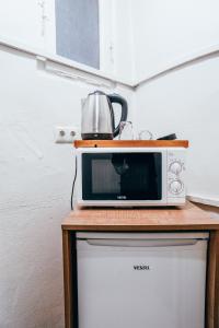 a microwave sitting on top of a refrigerator at Sufra Suite in Istanbul