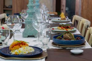 a table with plates of food and wine glasses at H2Otel By LD Hotel Boutique in La Mira