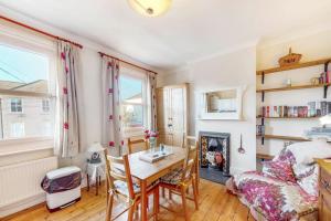 uma sala de estar com uma mesa e uma lareira em Beautiful two bedroom apartment in Honor Oak em Londres