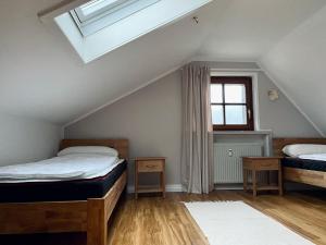 a attic bedroom with two beds and a skylight at Home-im-Harz in Lautenthal
