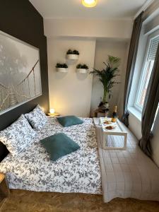 a bedroom with a bed with two pillows on it at The View and Design Studio in Zagreb