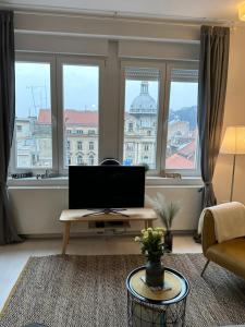 a living room with a large window and a television at The View and Design Studio in Zagreb