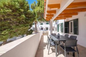 a patio with a table and chairs on a house at Villa Sol del Sur 15 in Son Xoriguer