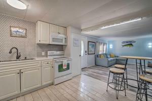 a kitchen and living room with a table and chairs at Family-Friendly Yankeetown Home with Grill! in Yankeetown