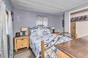 a bedroom with a bed and a wooden desk at Family-Friendly Yankeetown Home with Grill! in Yankeetown
