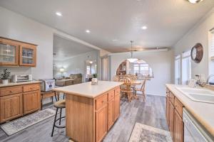 a kitchen with wooden cabinets and a kitchen island at Eufaula Escape with Deck - Steps to Lake! in Eufaula