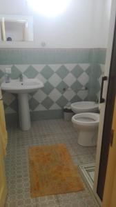 a bathroom with a sink and a toilet at Dodo Villa in Pointe aux Biches