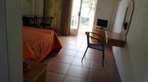 a bedroom with a bed and a table and chairs at Dodo Villa in Pointe aux Biches