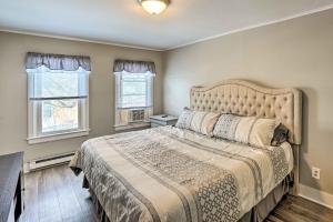 a bedroom with a large bed and two windows at Saratoga Springs Apartment half Mi to Downtown in Saratoga Springs
