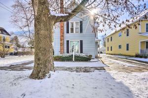 a house with a tree in the snow at Saratoga Springs Apartment half Mi to Downtown in Saratoga Springs