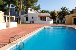 a swimming pool in front of a house at Casa Sol del Sur 4 in Son Xoriguer