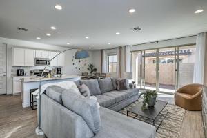 a living room with a couch and a kitchen at Mesa Vacation Rental with Community Pool Access in Queen Creek