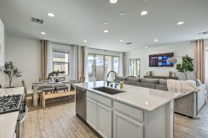 a kitchen and living room with a couch and a sink at Mesa Vacation Rental with Community Pool Access in Queen Creek