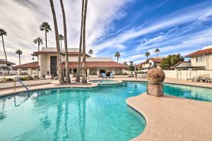 a swimming pool with palm trees in a resort at Central Scottsdale Home with Pool Access! in Scottsdale