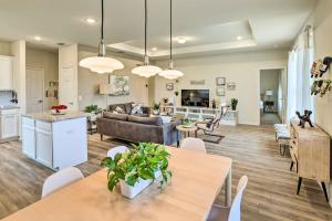 a living room with a dining room and a kitchen at Sleek Fort Worth Home with Covered Patio! in Fort Worth