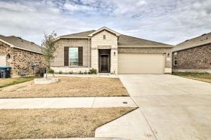 a large brick house with a garage at Sleek Fort Worth Home with Covered Patio! in Fort Worth