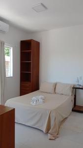 En eller flere senge i et værelse på Residencial Nai Frutuosa